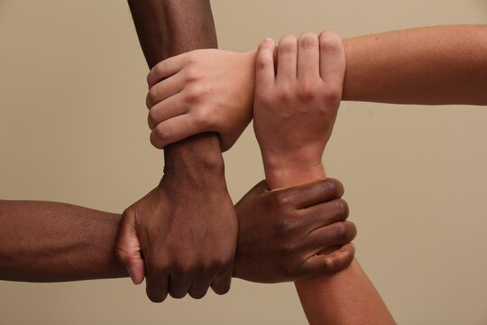 Hands reaching together, symbolizing unity and growth